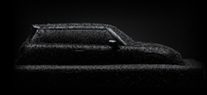 Side-view of the silhouette of a MINI covered in a dark lacquer.